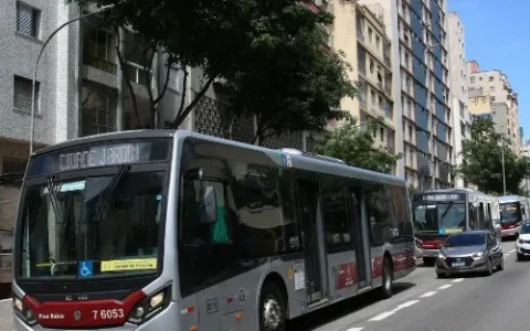 imagem de uma avenida movimentada com ônibus e carros